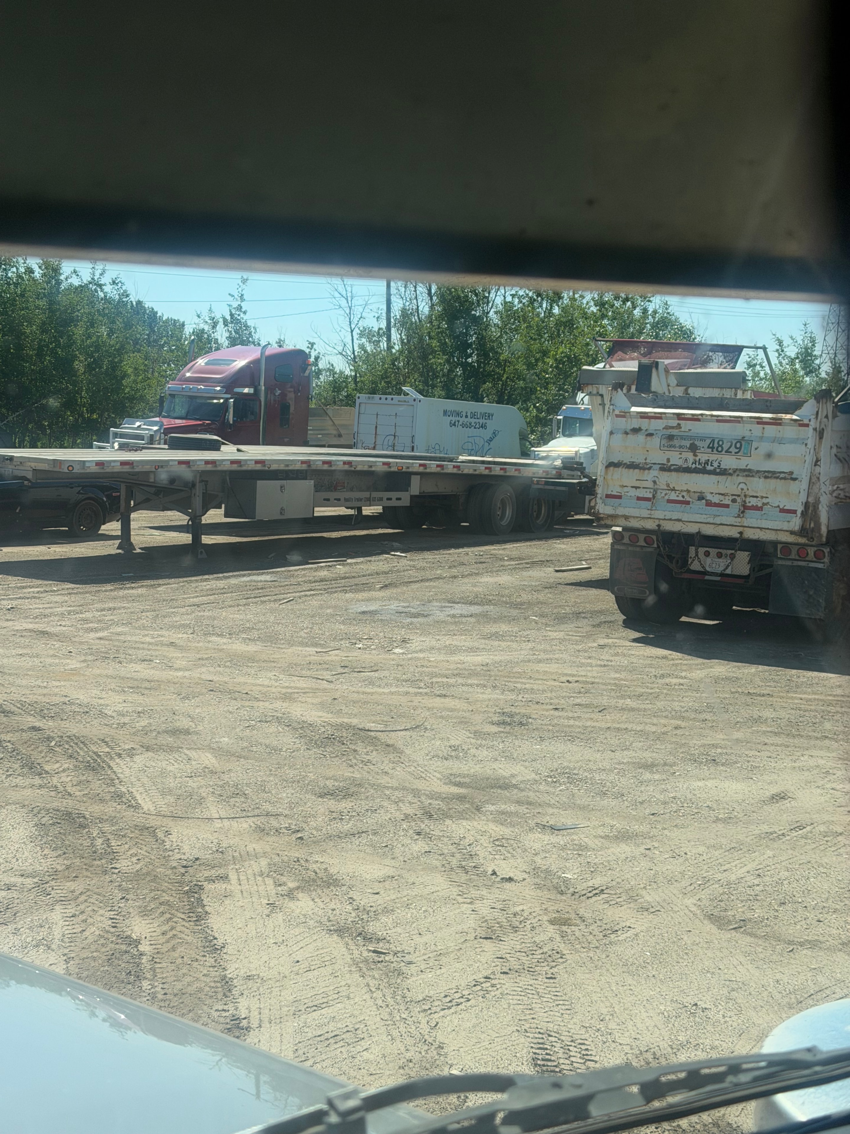Flatbed trailers lined up at Ladhar Trucking yard in Edmonton